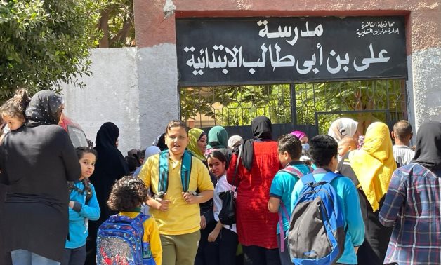 FILE - Students in front of a primary school in Cairo, Egypt