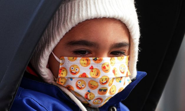 FILE - Child wearing mask - REUTERS