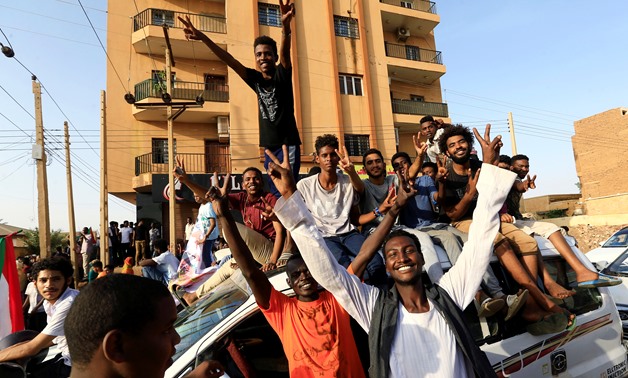 Sudanese people chant slogans as they celebrate, after Sudan's ruling military council and a coalition of opposition and protest groups reached an agreement to share power