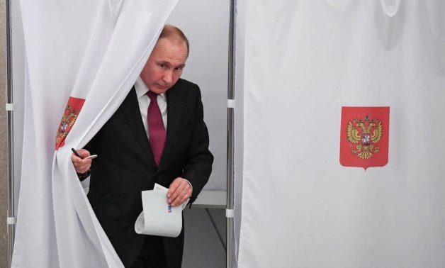 Russian President Vladimir Putin is seen at a polling station in Moscow. (photo credit: YURI KADOBNOV/POOL VIA REUTERS)