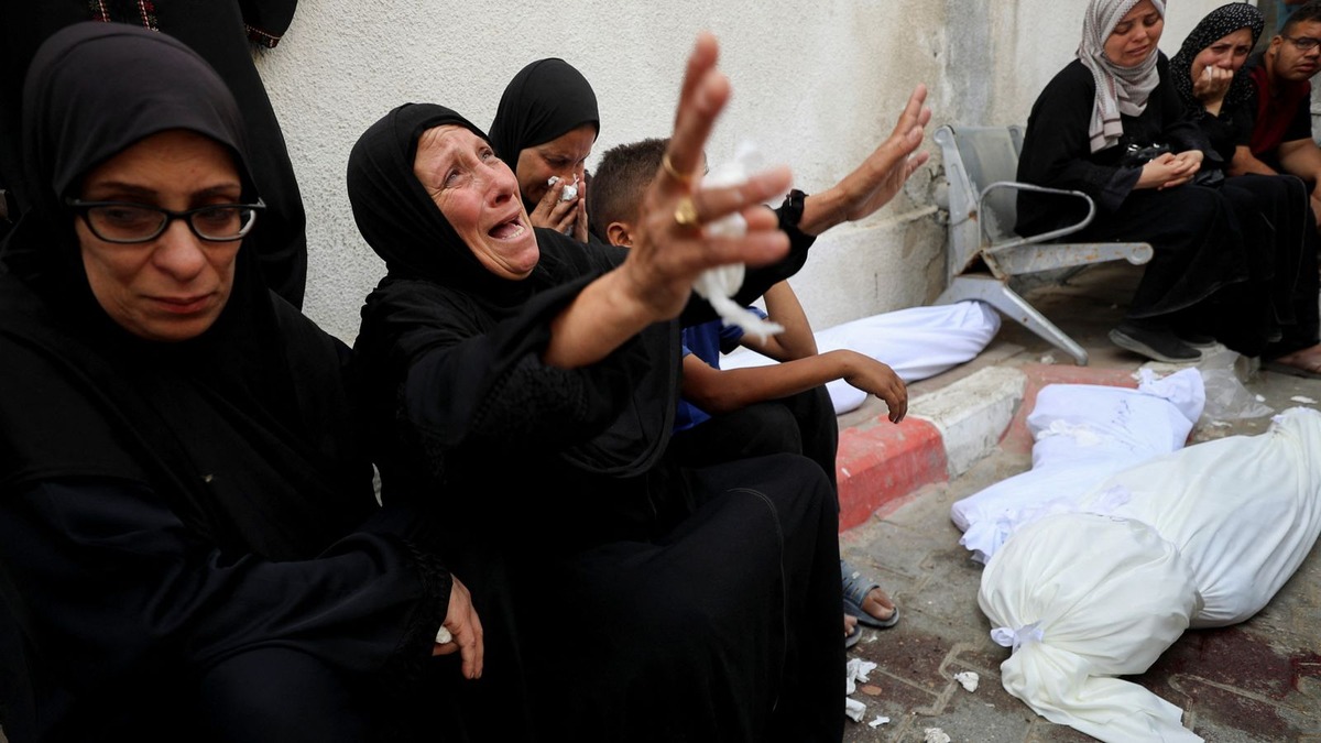 women wearing black crying in Gaza that has now being declared famine, Gaza now a ‘slaughterhouse’ — British Surgeon