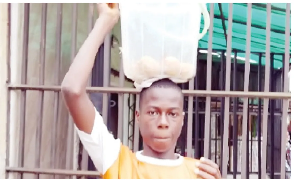 boy carrying a bucket of buns on head my parents were struggling to survive