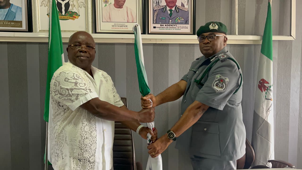 New Oyo/Osun Controller, Comptroller, Gambo Iyere Aliyu, and outgoing Comptroller Joseph Olugbuyi Adelaja holding a staff
