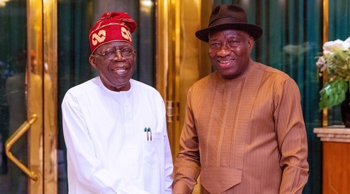 President Bola Tinubu in a handshake with former President Goodluck Jonathan