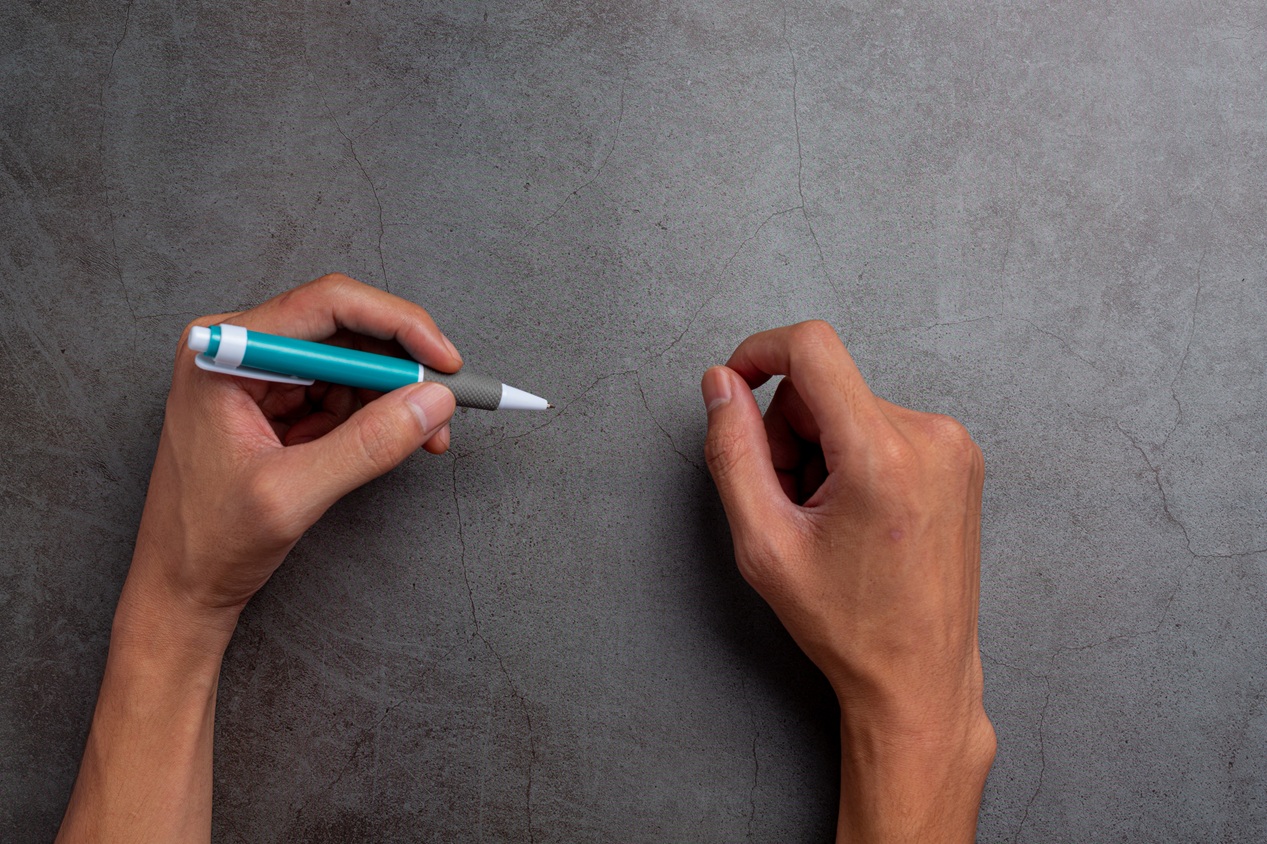 a woman left-hand with a pen.Left hander day concept.