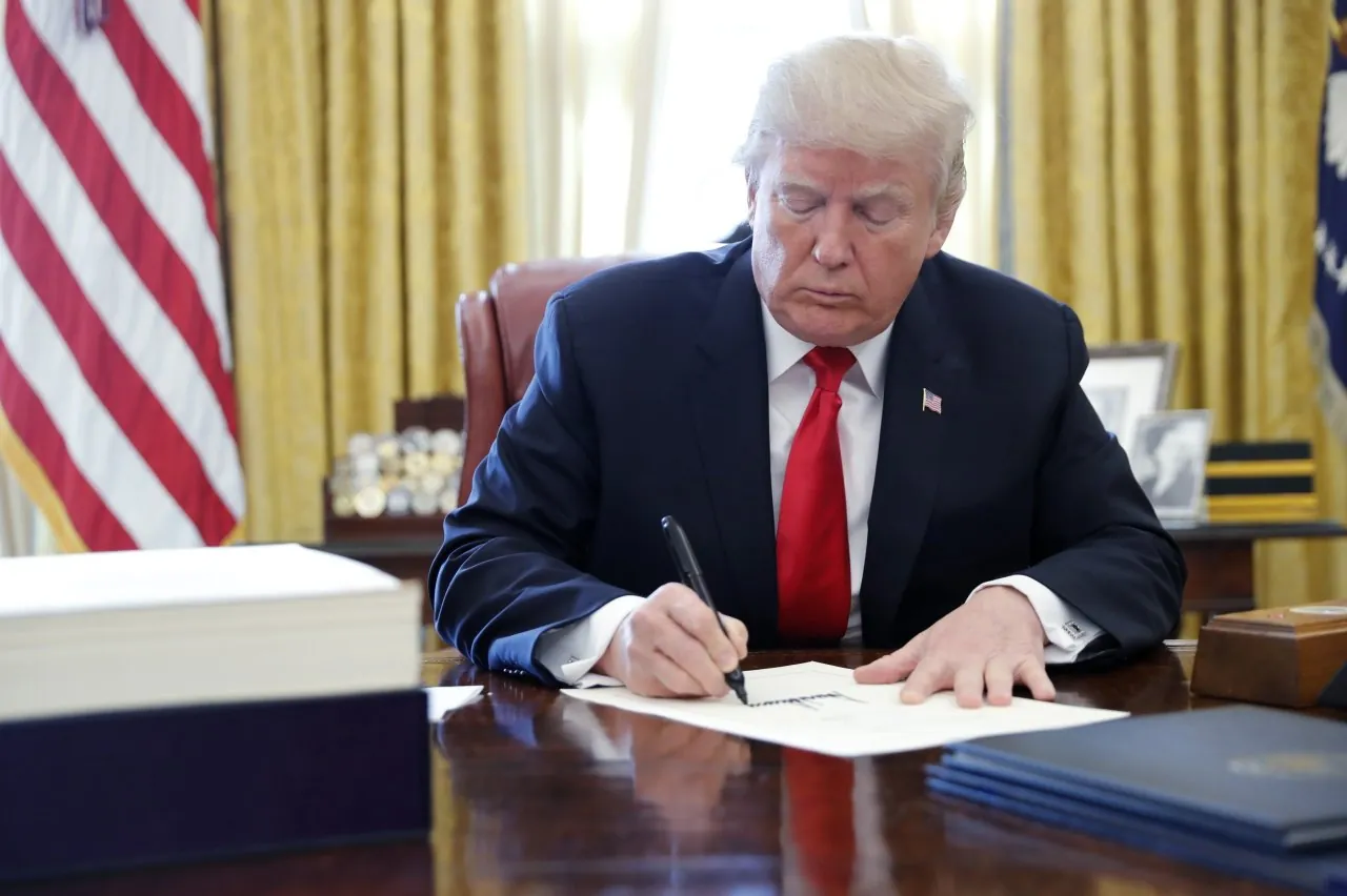 Donald Trump, Donald Trump signing a document,
