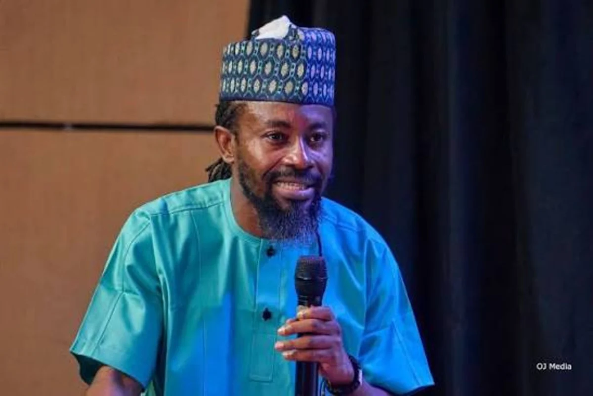 Moses Paul holding a microphone